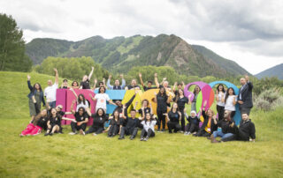 Winners of the Aspen Challenge celebrate after presenting on stage at the Aspen Ideas Festival