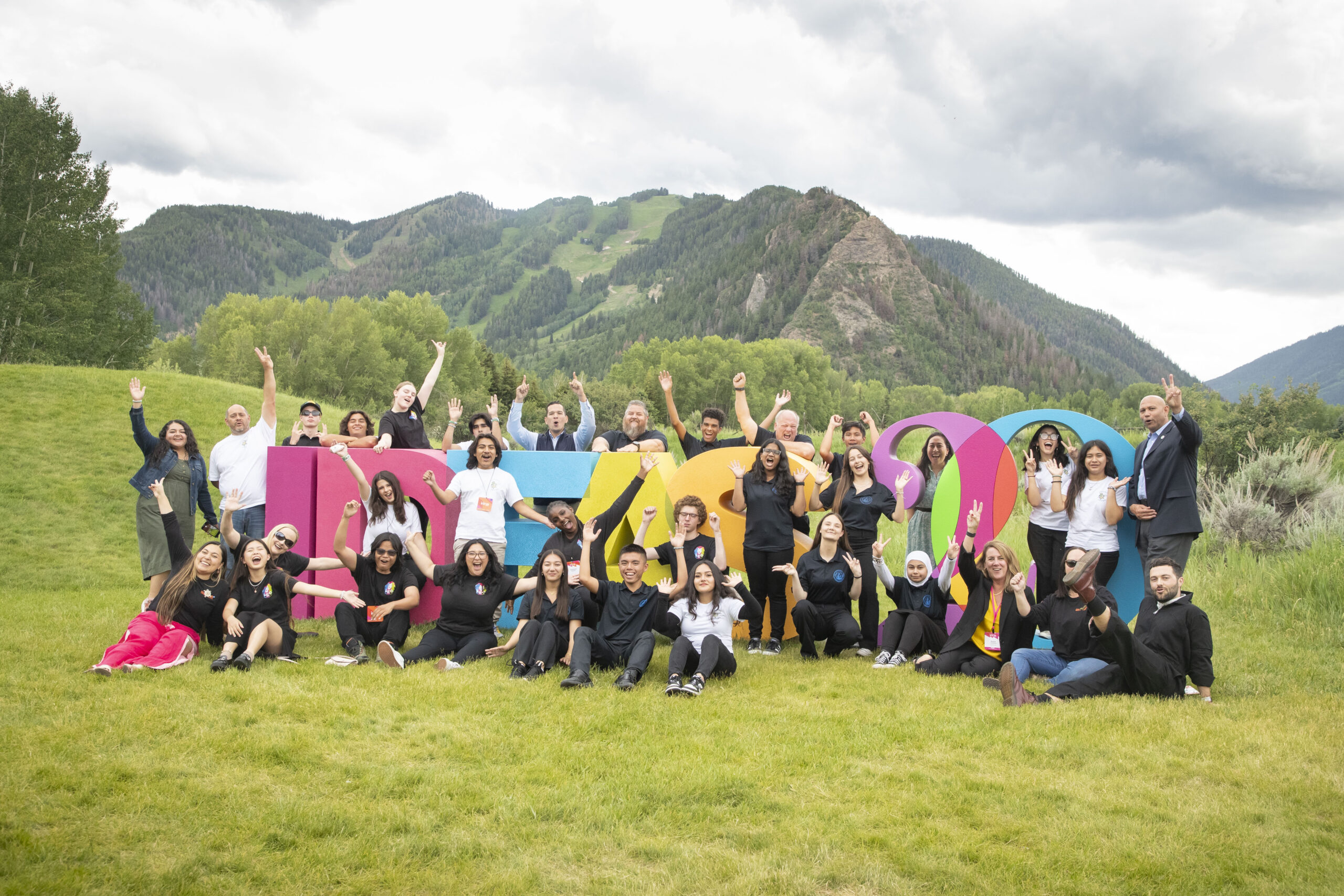 Winners of the Aspen Challenge celebrate after presenting on stage at the Aspen Ideas Festival